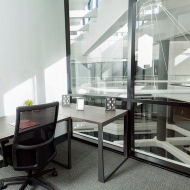 Interior shot of a solo workstation with a glass pane