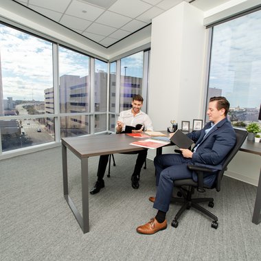 Professionals discussing business ideas in a shared office