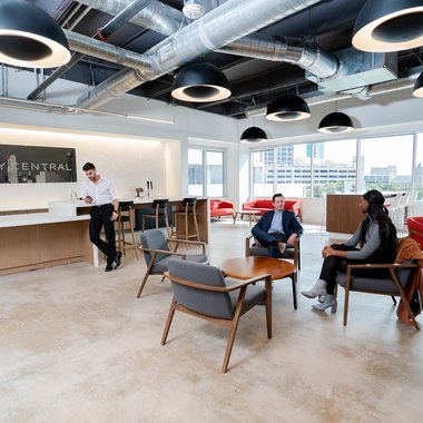 Workers engaged in conversation in a shared workspace