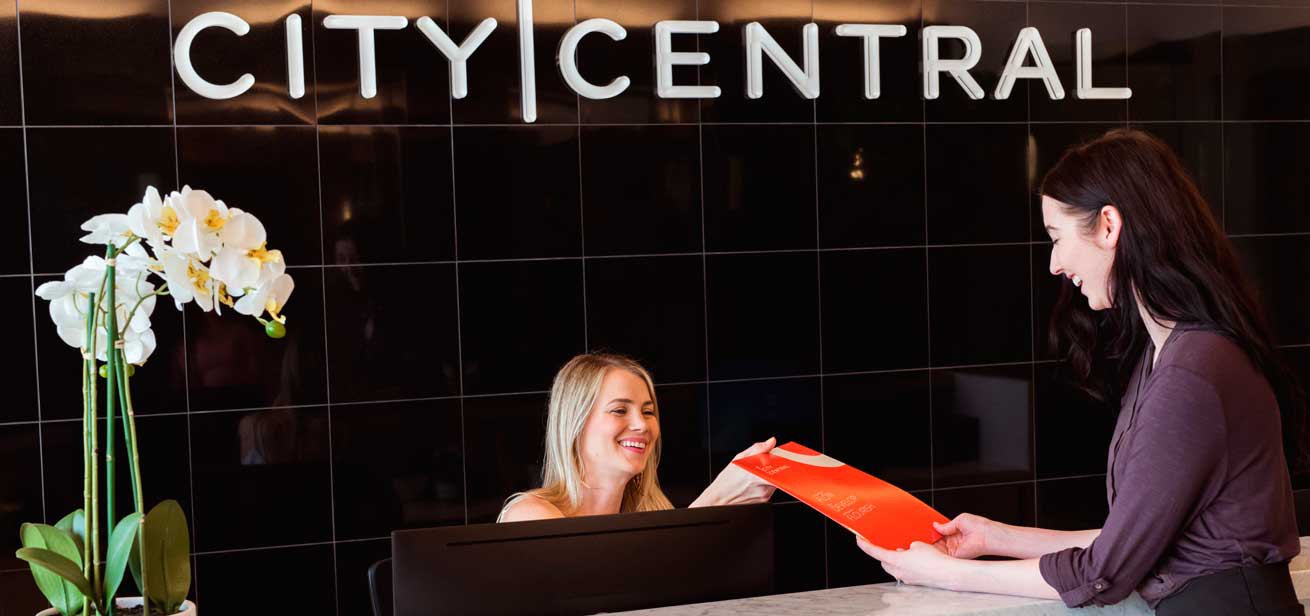 Receptionist greeting a visitor at City Central
