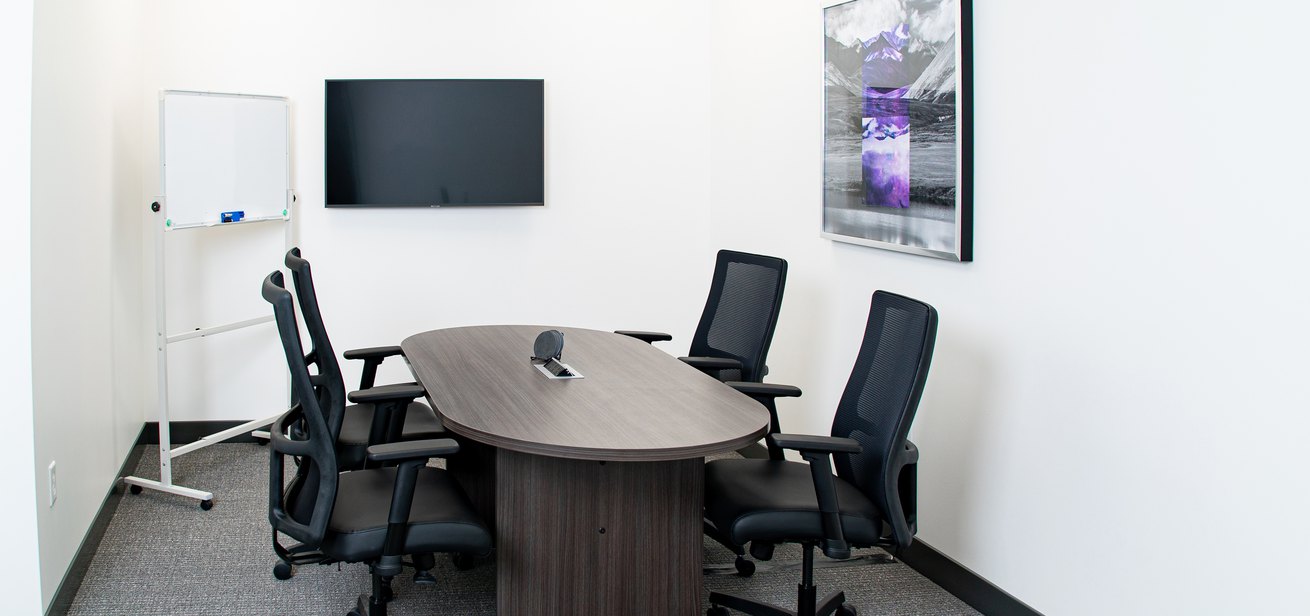 A small-sized meeting room equipped for a video conference