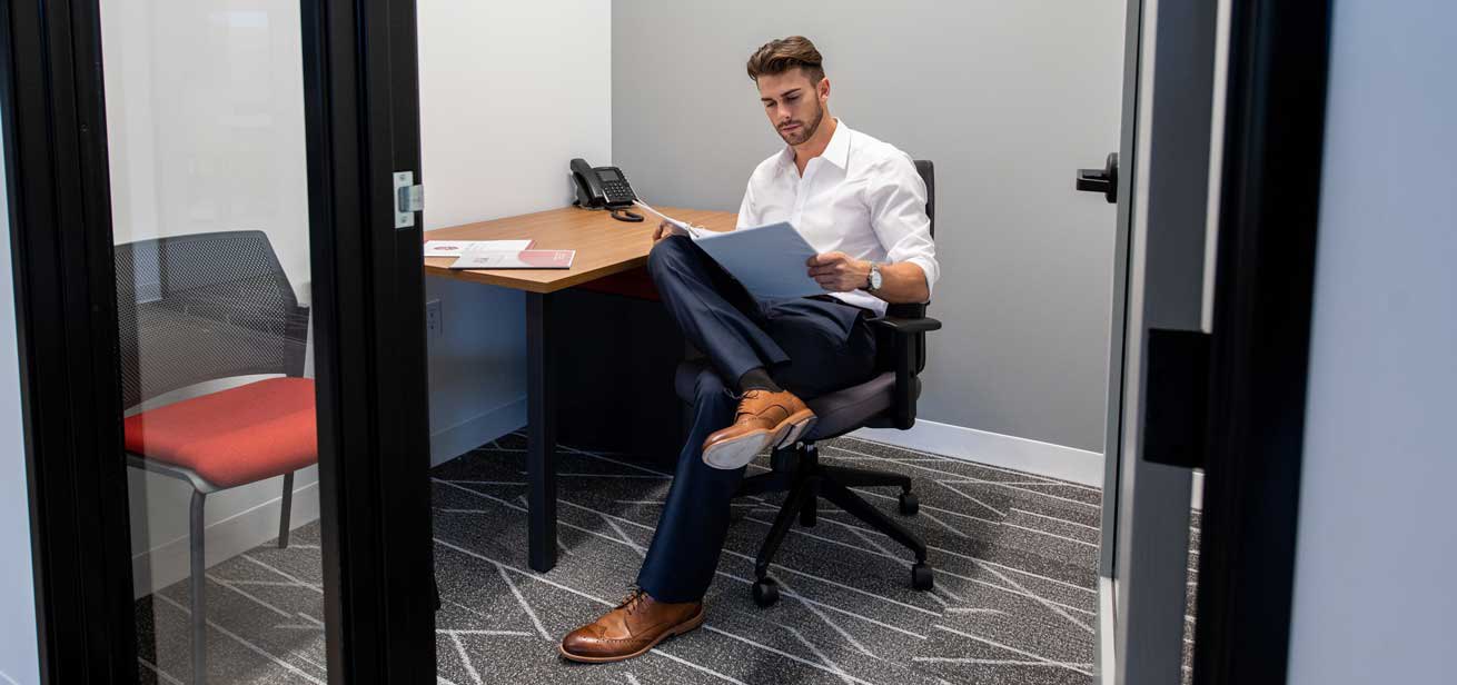 A professional reading a business plan in his private working space